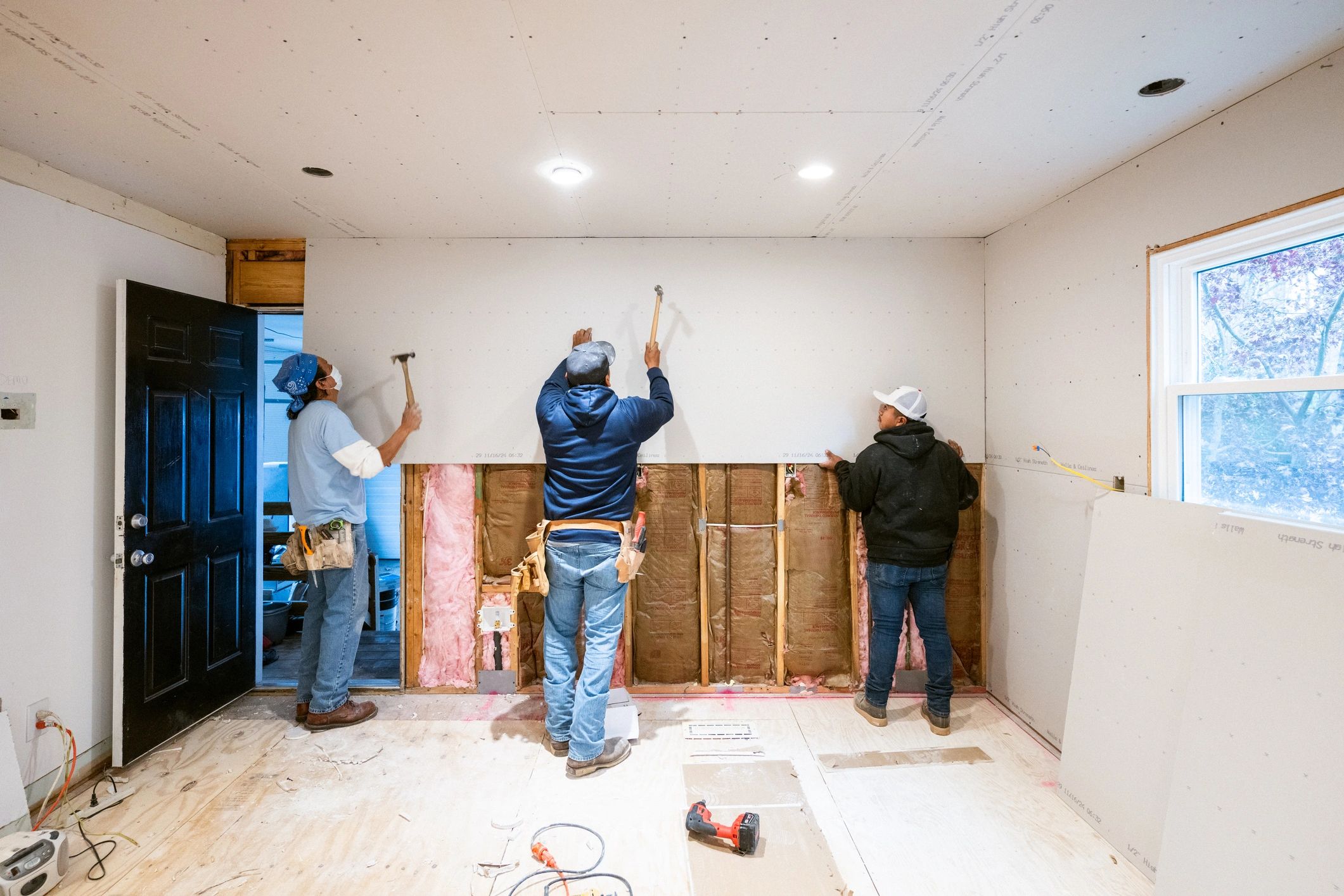 Drywall installers working on a commercial interior