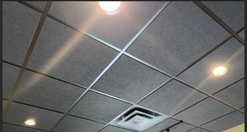 Black acoustic tile ceiling installation